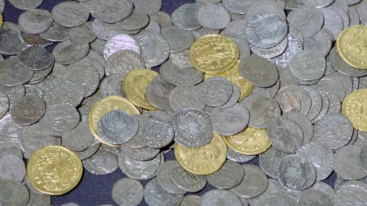 GROUP OF METAL DETECTORISTS UNCOVER HOARD OF COINS IN ENGLAND